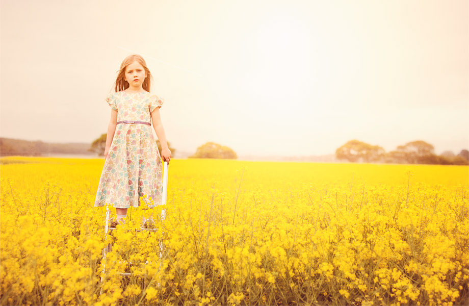Little-girl-in-a-yellow-field-in-a-Sue-Hill-dress